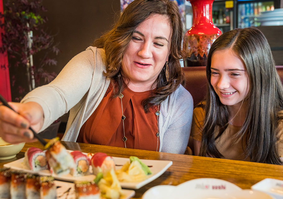 Mother and daughter eating sushi in Bend, OR