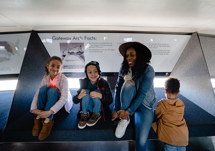 Britt Null and her family pose in front of a display inside the top of the Gateway Arch in St. Louis, MO
