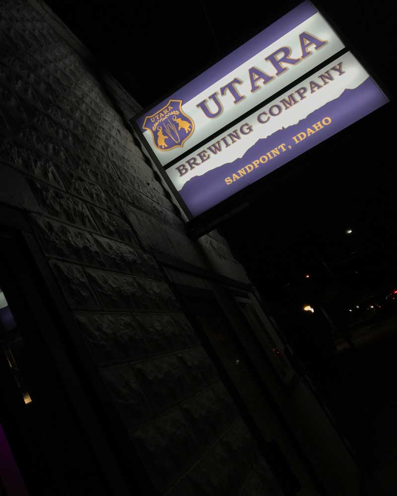 a sign reading Utara Brewing Company Sandpoint Idaho on a nightime street