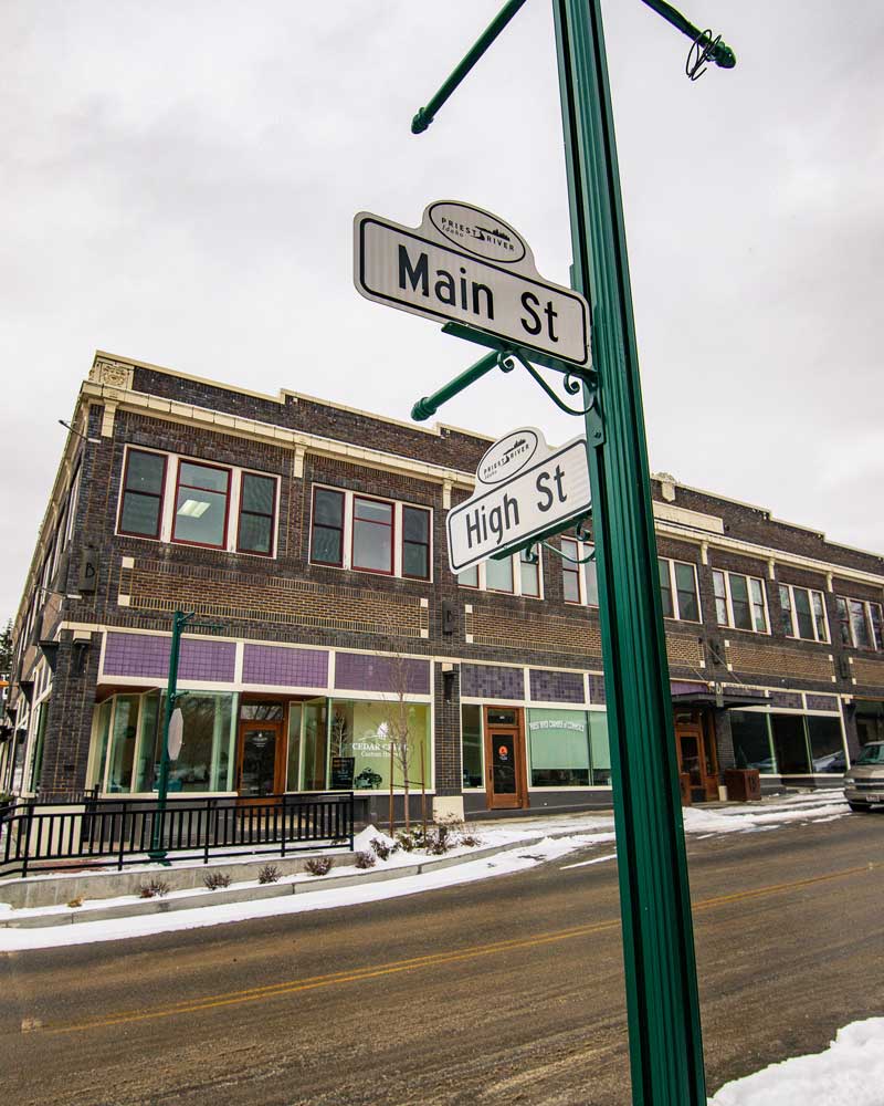  a snowy brick building in downtown Priest River

				